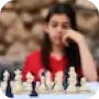 chess board in focus, out
					of focus long haired woman looking at the chess board